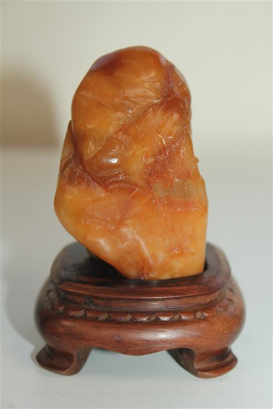 A Chinese Tianhuang stone landscape carving, 136g., 7 x 4 x 3.5cm, wood stand